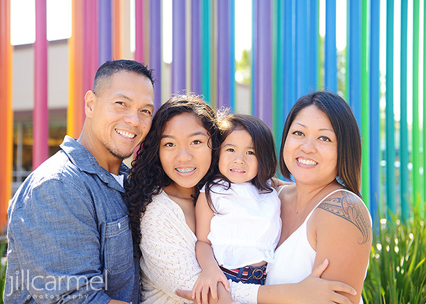 Family standing in front of colorful artwork in Sacramento