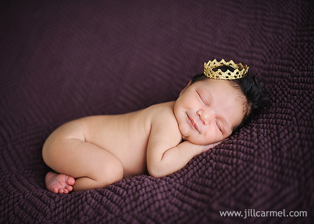 baby on purple blanket with crown smiling in sacramento