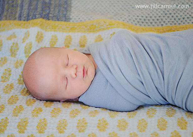 newborn baby having pictures on handmade blanket