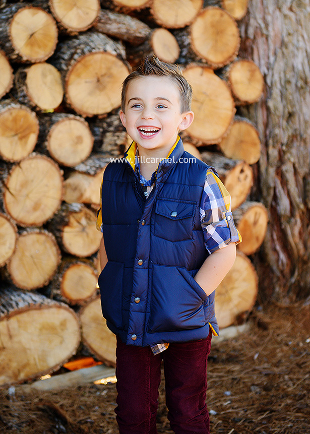 laughing in front of logs at apple hill