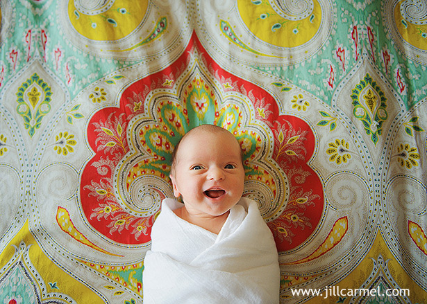baby smiling on a moroccan bedspread in los angeles