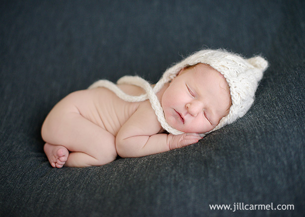 tiny baby in knitted white aviator hat