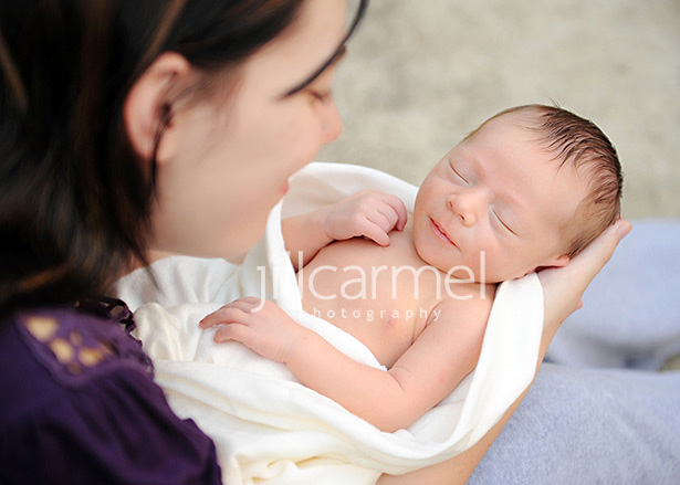 mom holding newborn baby for his first photo shoot in sacramento