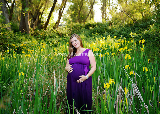 standing in a field of yellow irises a perfect complement to her purple maxi dress