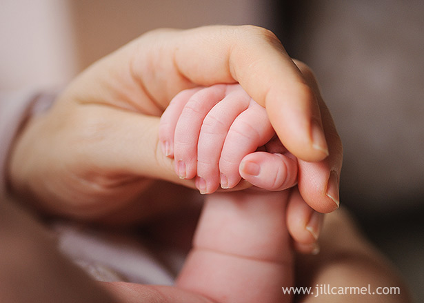 mama holding her newborn baby's hand