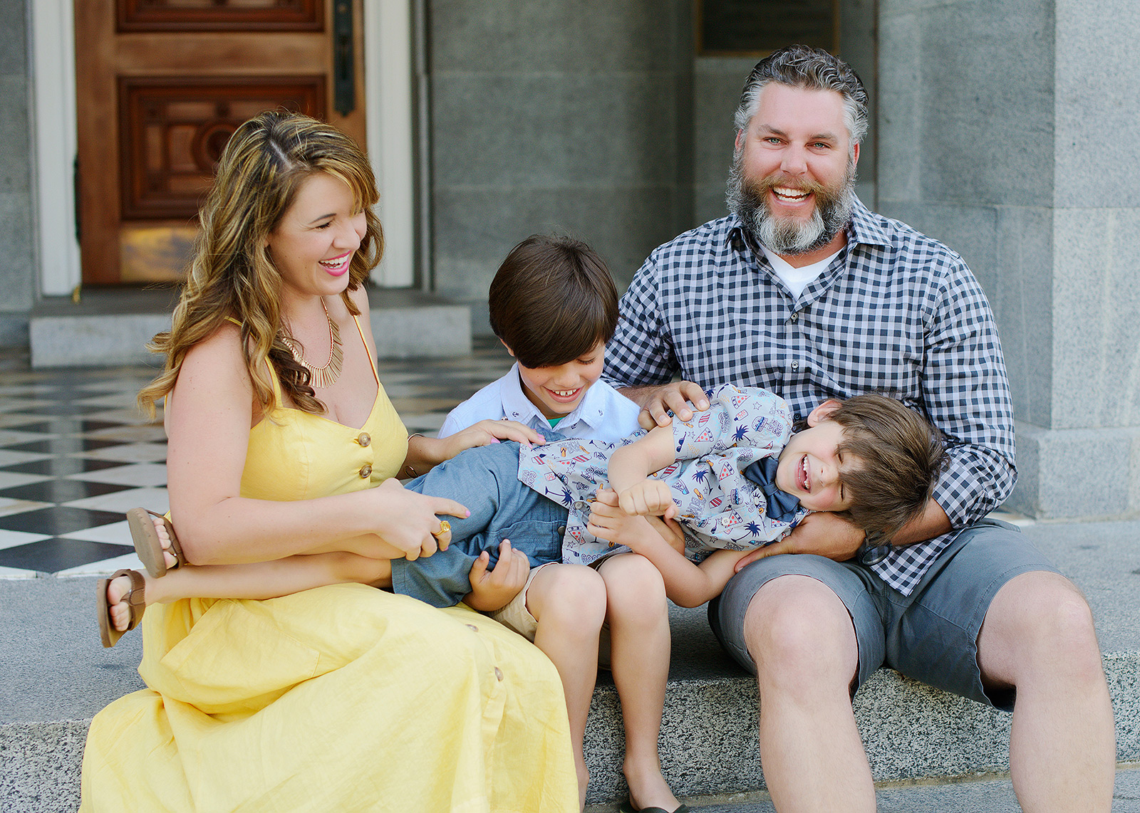 Fun family photos with laughs and a yellow dress at the sacramento capitol
