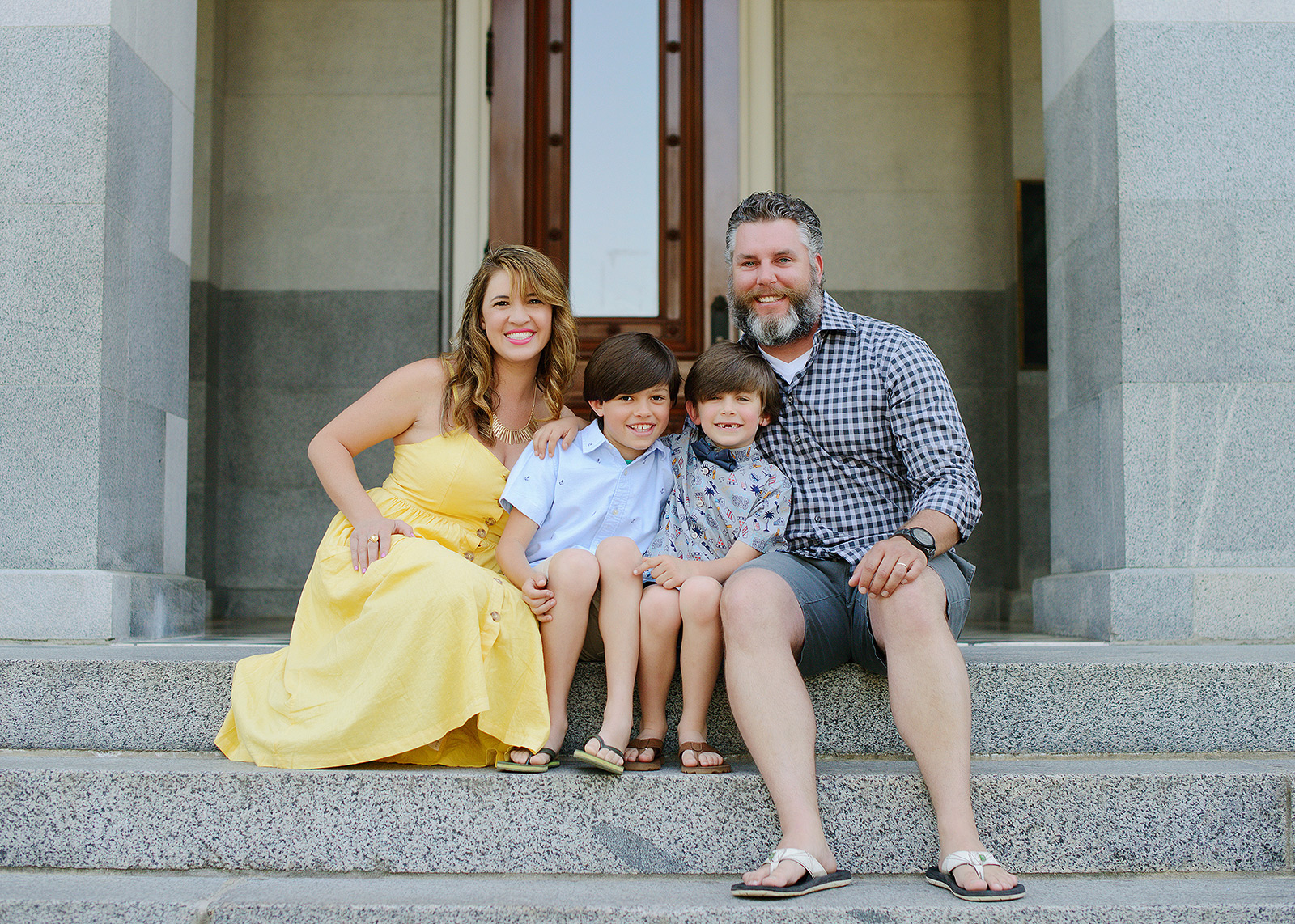 Family photos sitting on steps with flip flops at the sacramento capitol