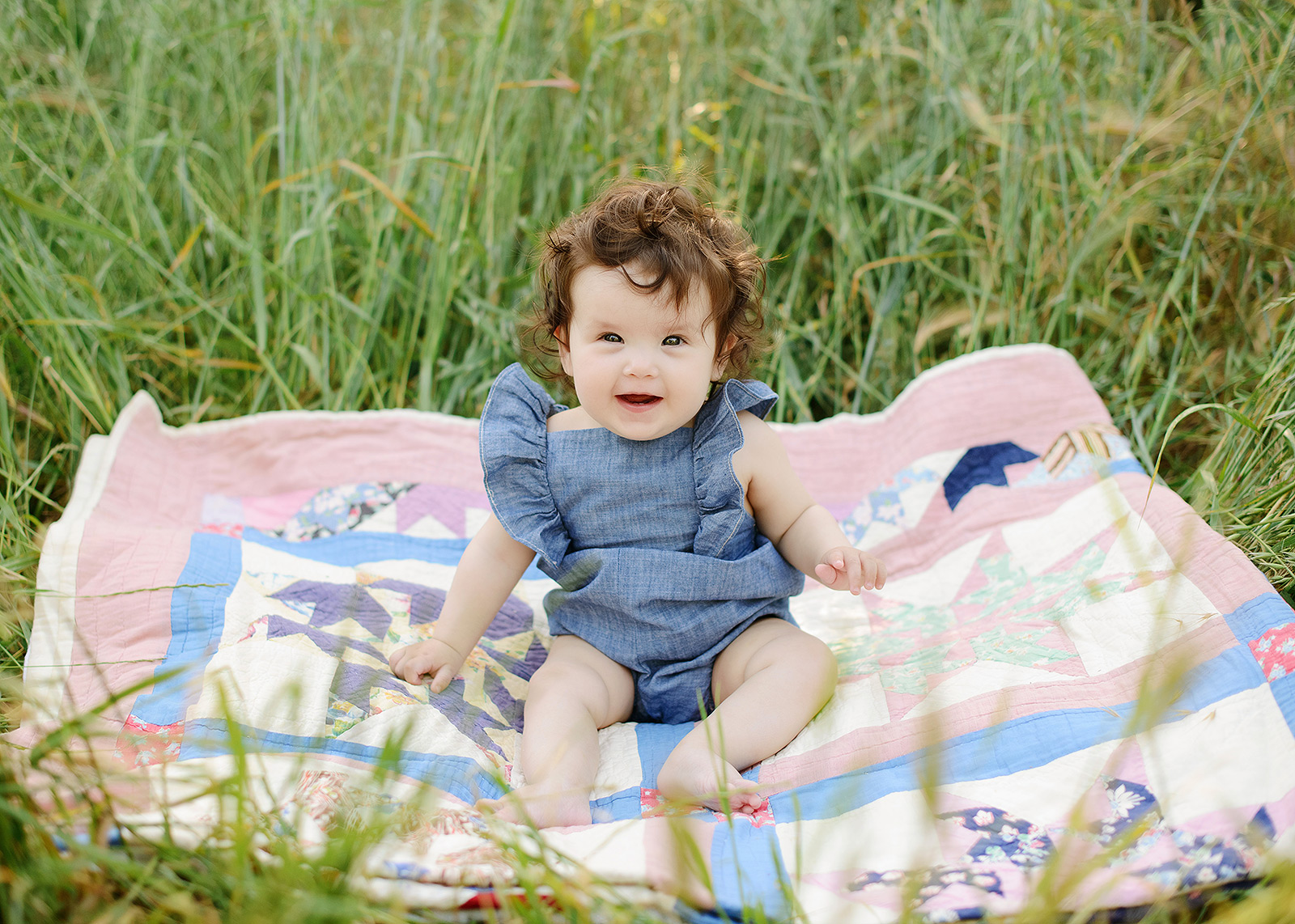 Baby on family heirloom quilt in the grass