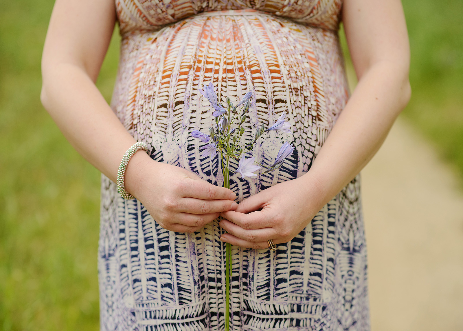 Colorful close-up of maternity bump holding Folsom wildflowers