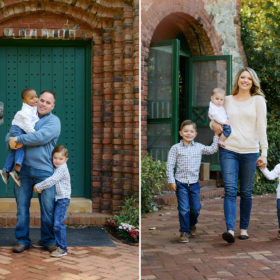 Family holding hands in front of brick and green door