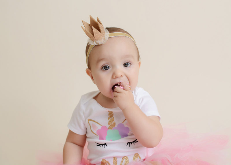 Baby Girl Eating Pink Frosting in Pink Unicorn Tutu Outfit