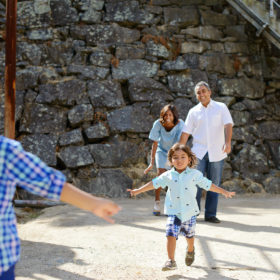 Boys running from mom and dad with stone background at Folsom Powerhouse