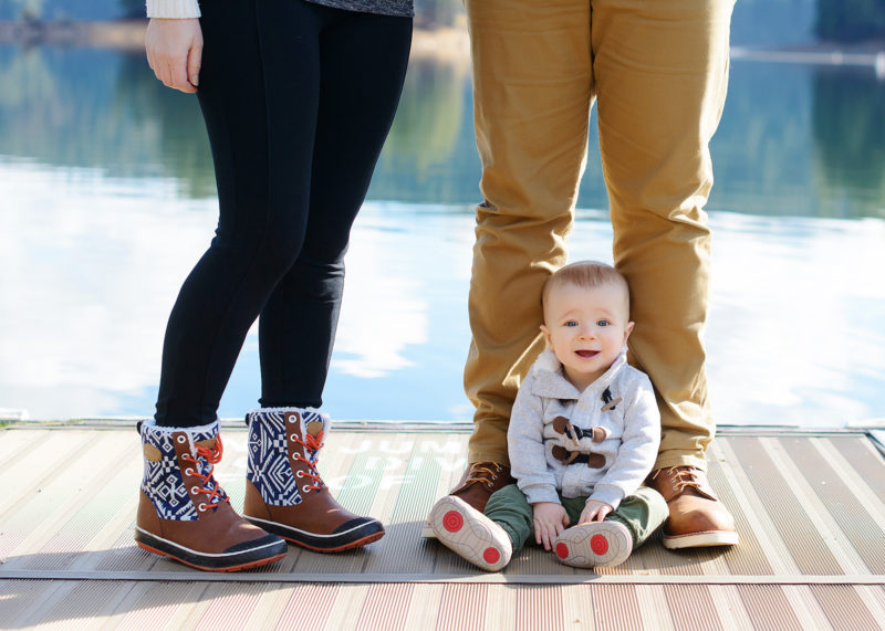 Baby Boy Wearing Boots by Parents Feet by Pollock Pines Lake
