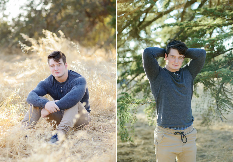 Male teenager posing for senior portraits on yellow grass and trees
