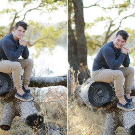 Male teen sitting on fallen log in Folsom park