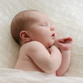 Newborn Sleeping on White Muslin