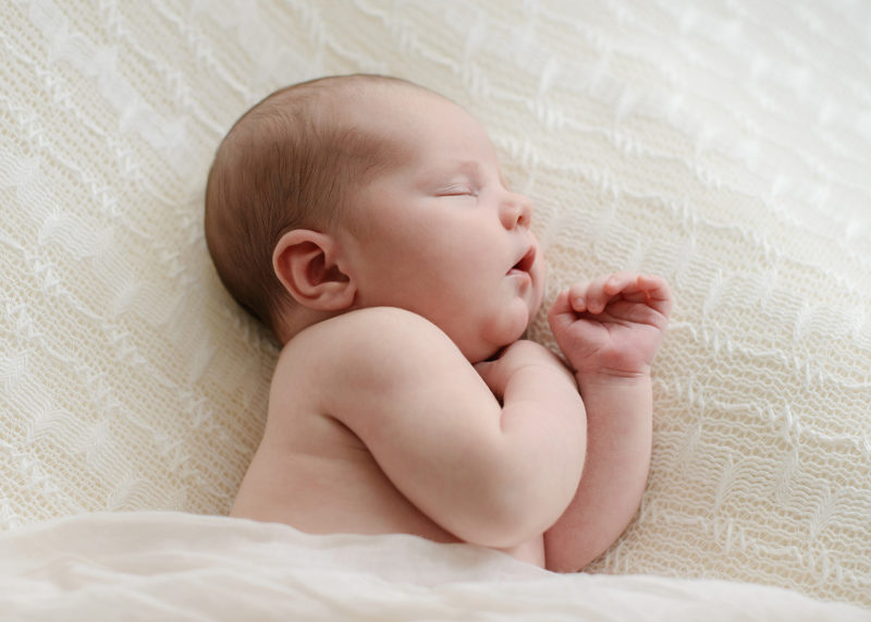 Newborn Sleeping on White Muslin