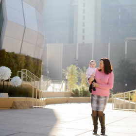 Mom Carrying Baby Boy in front of Golden 1 Center in Natural Light