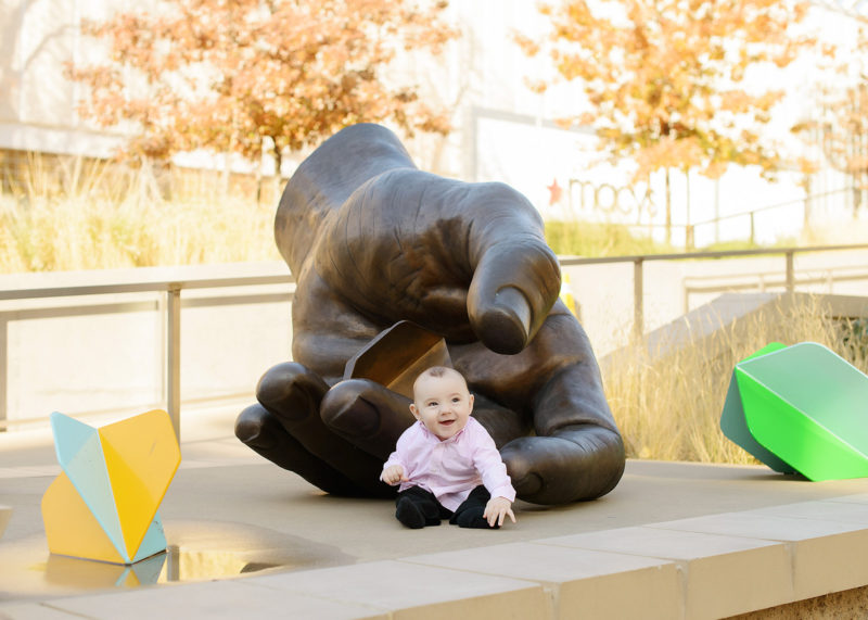 Baby Boy Laughing by Hand Sculpture at Golden 1 Center
