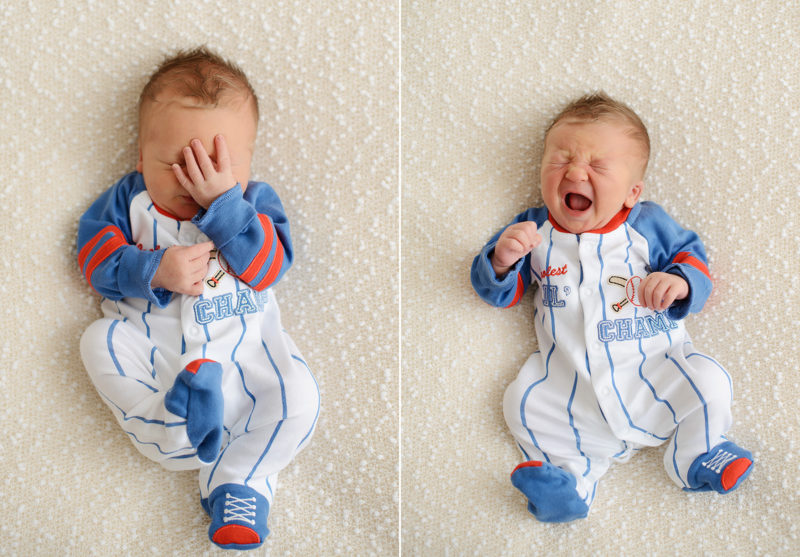 Newborn baby boy crying in baseball outfit