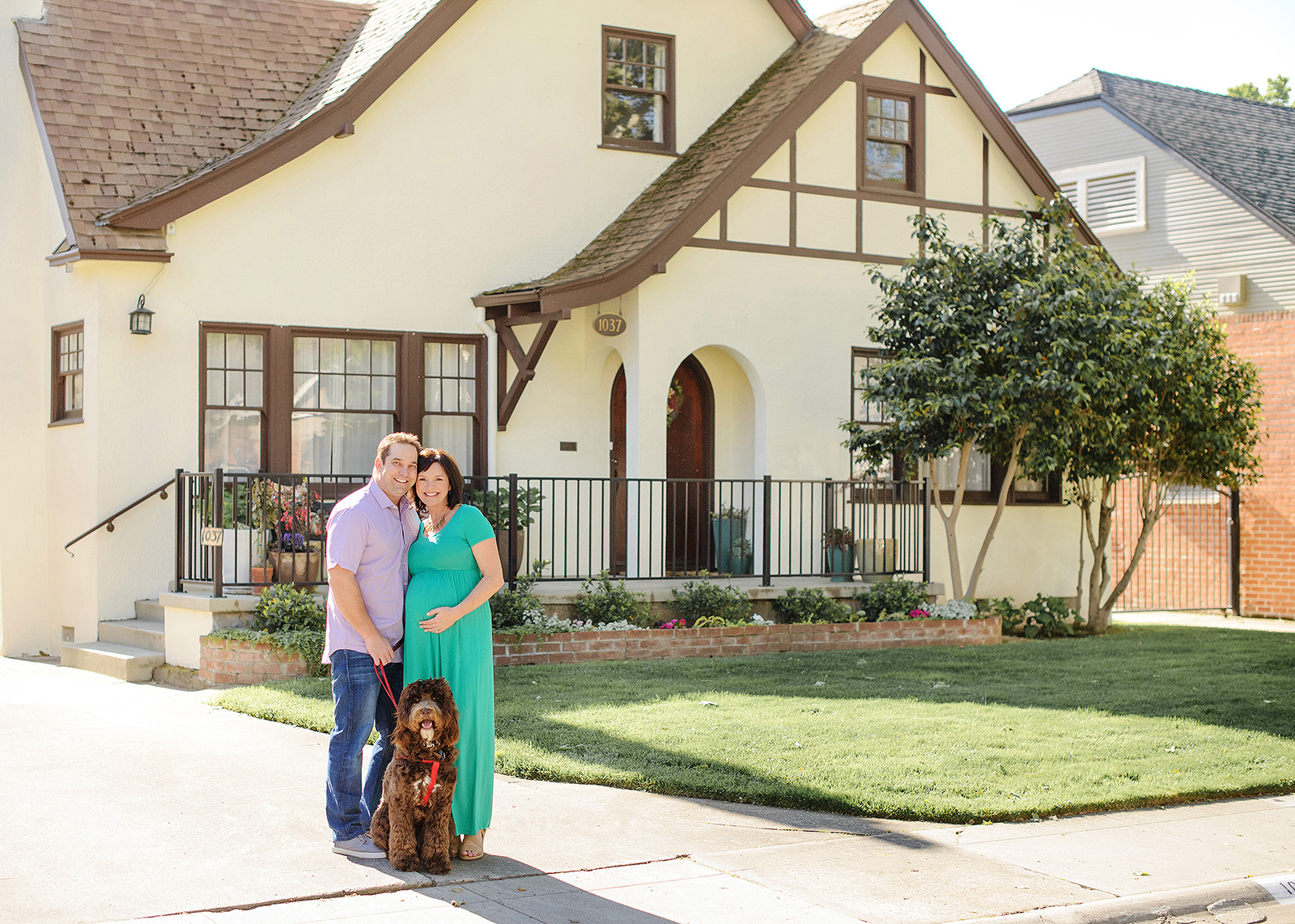 Maternity photo with dog in front of Sacramento home