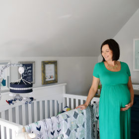 Pregnant mom in baby boy nursery