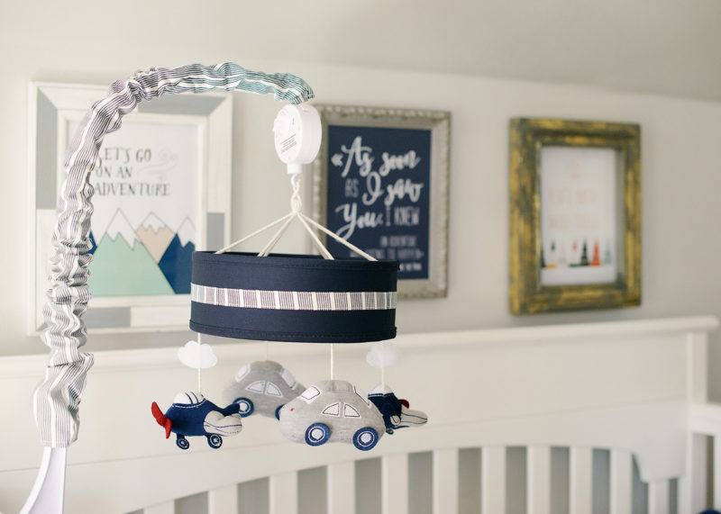 Blue and gray planes and cars baby mobile over crib