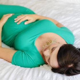 Pregnant woman lying on bed maternity photo