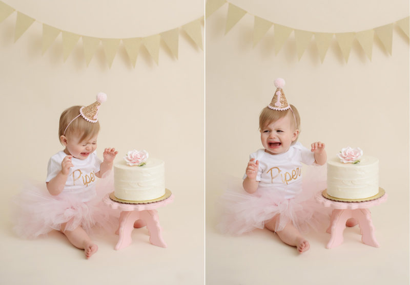 Baby girl in pink tutu smashing cake and crying