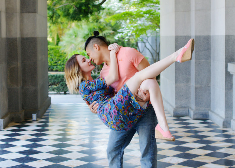 Wife is swept up off her feet on black and white checkered floor at State Capitol Sacramento