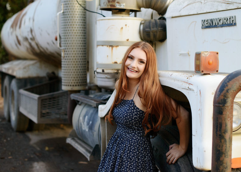 Senior High School Girl Next to White Truck Rig
