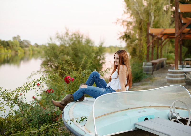 Senior Girl Sitting on River Boat