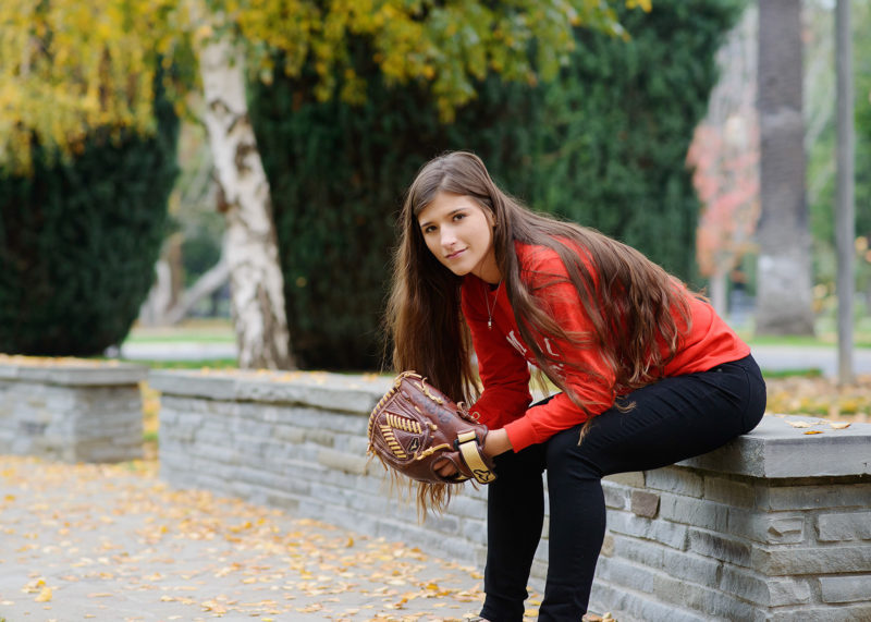 Senior softball player portrait with mitt in Sacramento