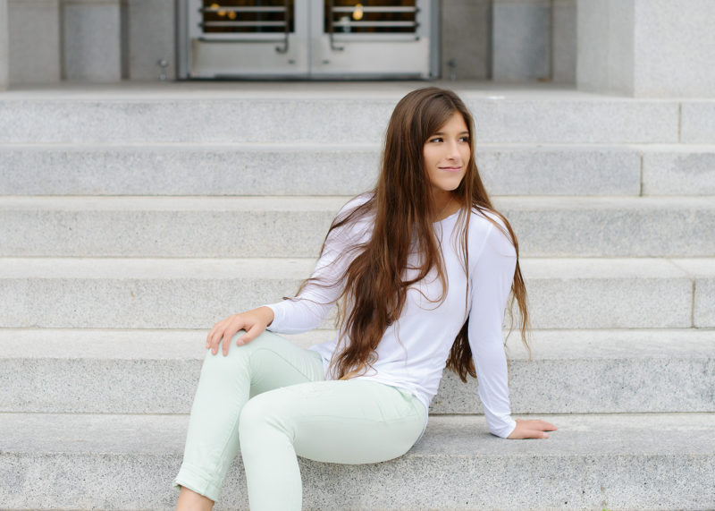 Senior girl in front of steps in Sacramento State Capitol