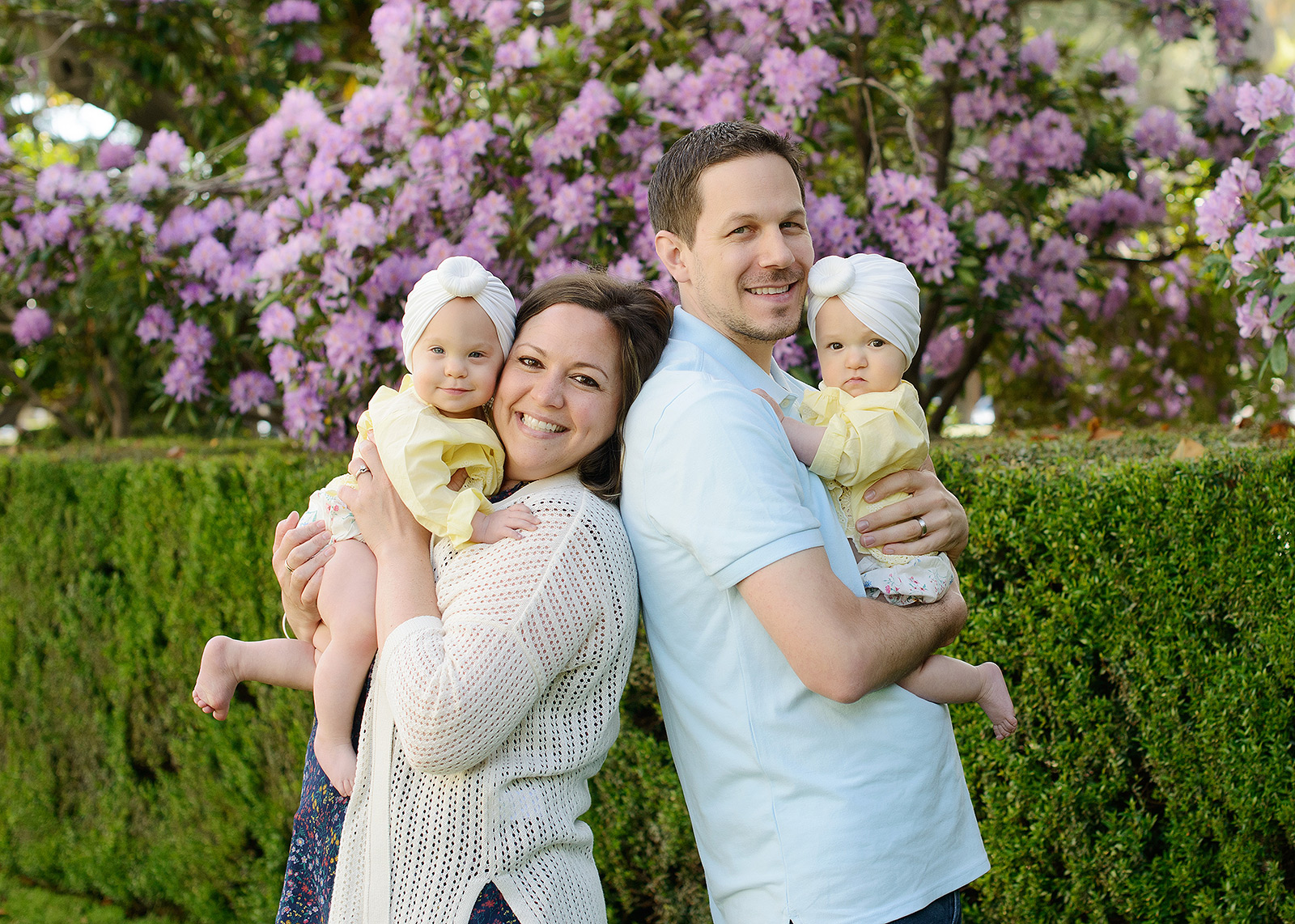 Family photos with twin baby girls outdoors with flowers at Sacramento State Capitol