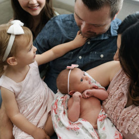 Family photos with newborn baby girl in home