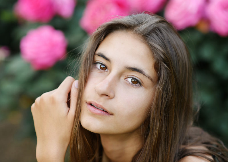 Senior portrait of girl close up with pink flowers in State Capitol