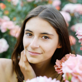 Senior portrait of teen girl in the middle of pink flowers in State Capitol