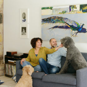 Family photo with the dogs on gray couch in home