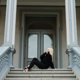 Senior portrait of teen girl sitting down on State Capitol steps