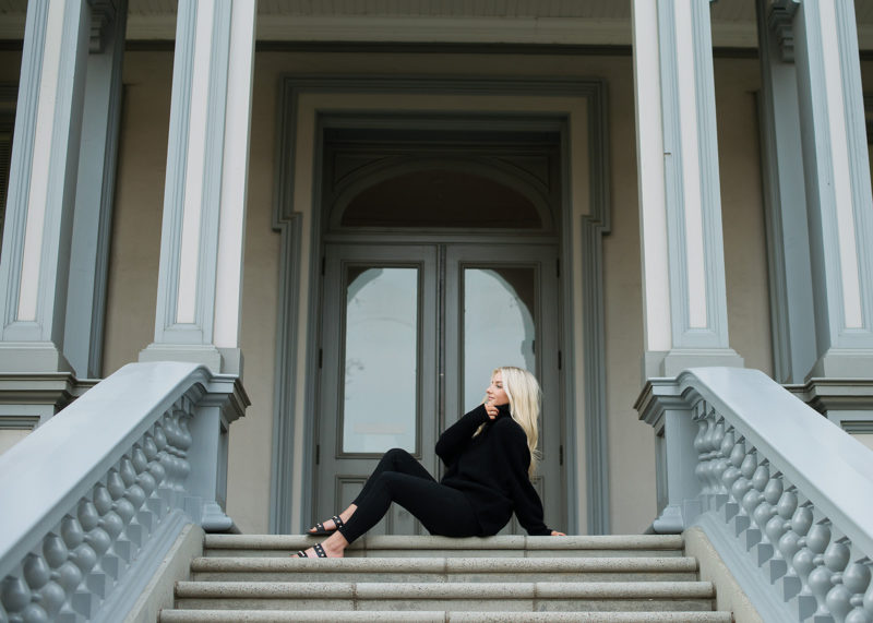 Senior portrait of teen girl sitting down on State Capitol steps