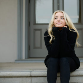 Senior portrait of teen girl wearing black turtleneck on State Capitol steps