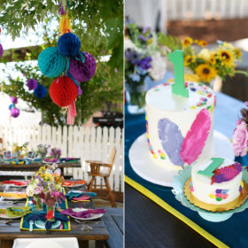 Colorful festive streamers and lanterns and 1st birthday cake with feathers