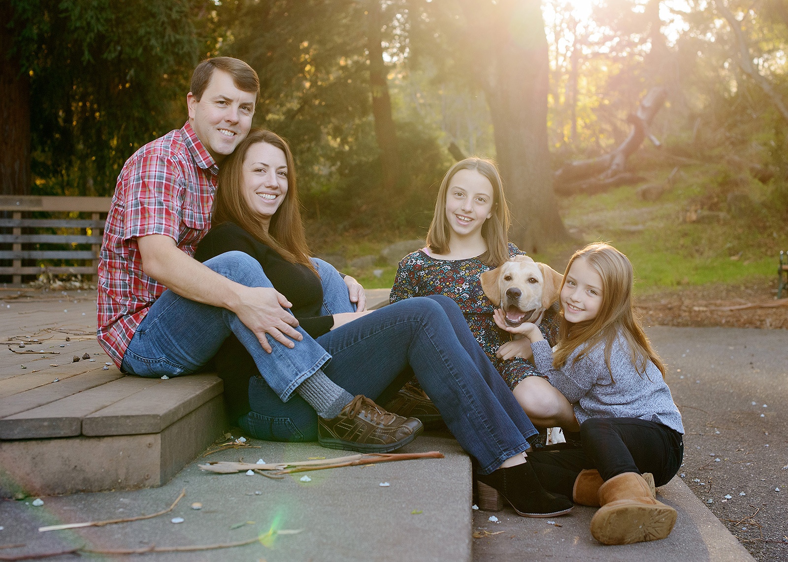 Family photo with sunlight on steps in outdoor Saratoga fall