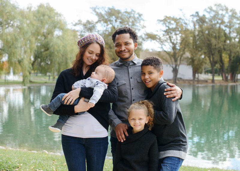 Mixed race family photo by the lake in Sacramento