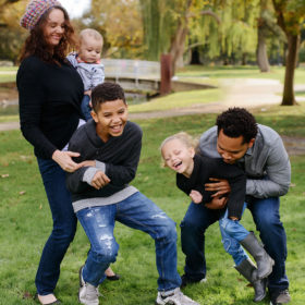 Mixed race family laughing in Sacramento outdoors Fall season