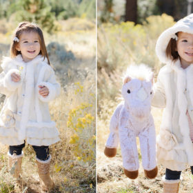 Daughter dressed in boots and coat with unicorn toy in golden grass in Nevada