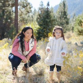Mom and daughter in golden grass and wildflowers in Nevada