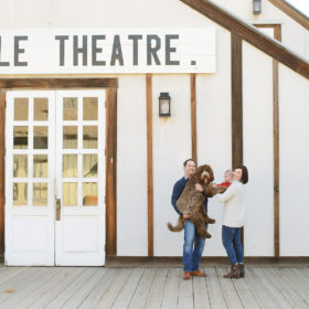 Family with dog posing in front of Eagle Theatre in Old Sacramento