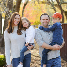 Family photo outdoors with tree foliage